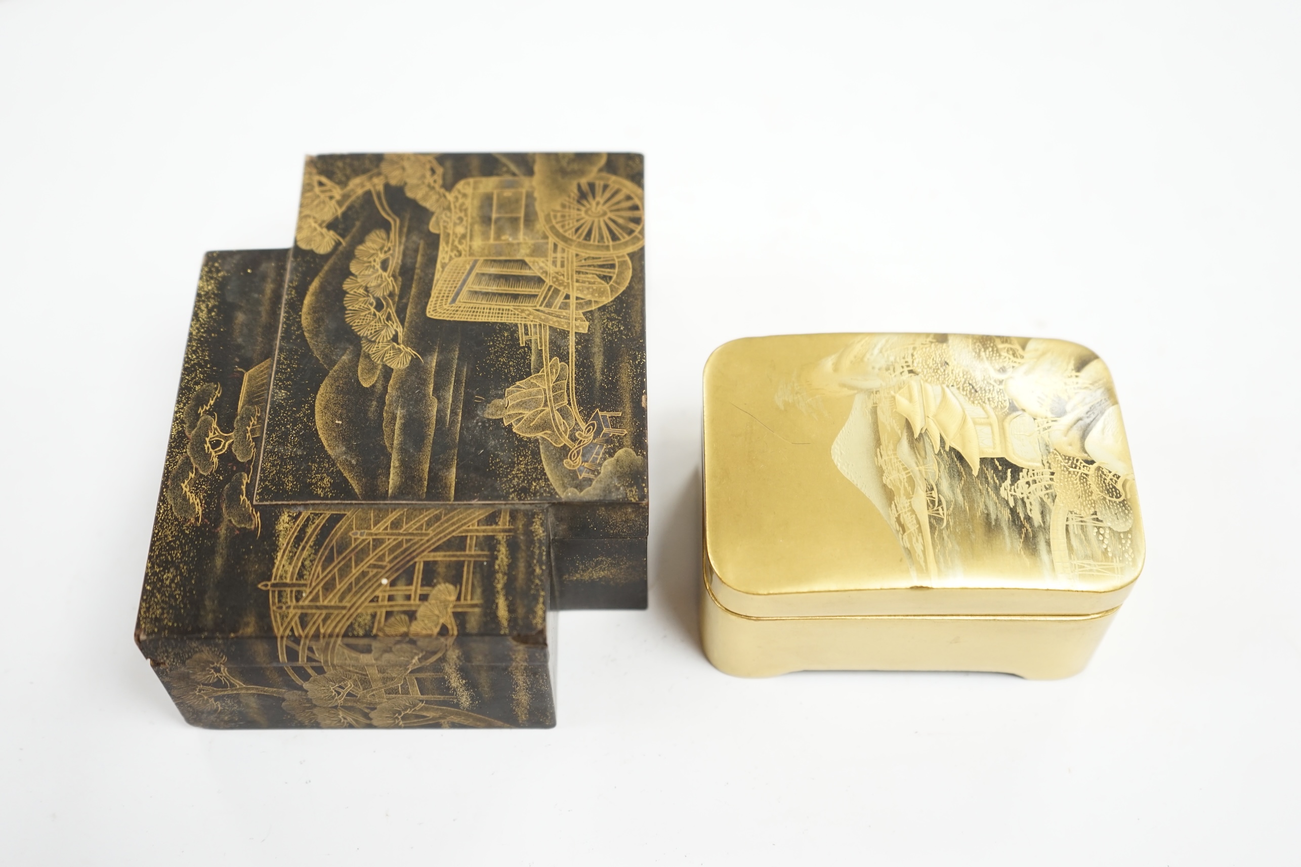 Two Japanese lacquer boxes: one black with gilt decoration, the other gilt with a scene of Mount Fuji etc, largest box 12cm wide. Condition - black and gilt box has some grazes to top edges, gilt box good